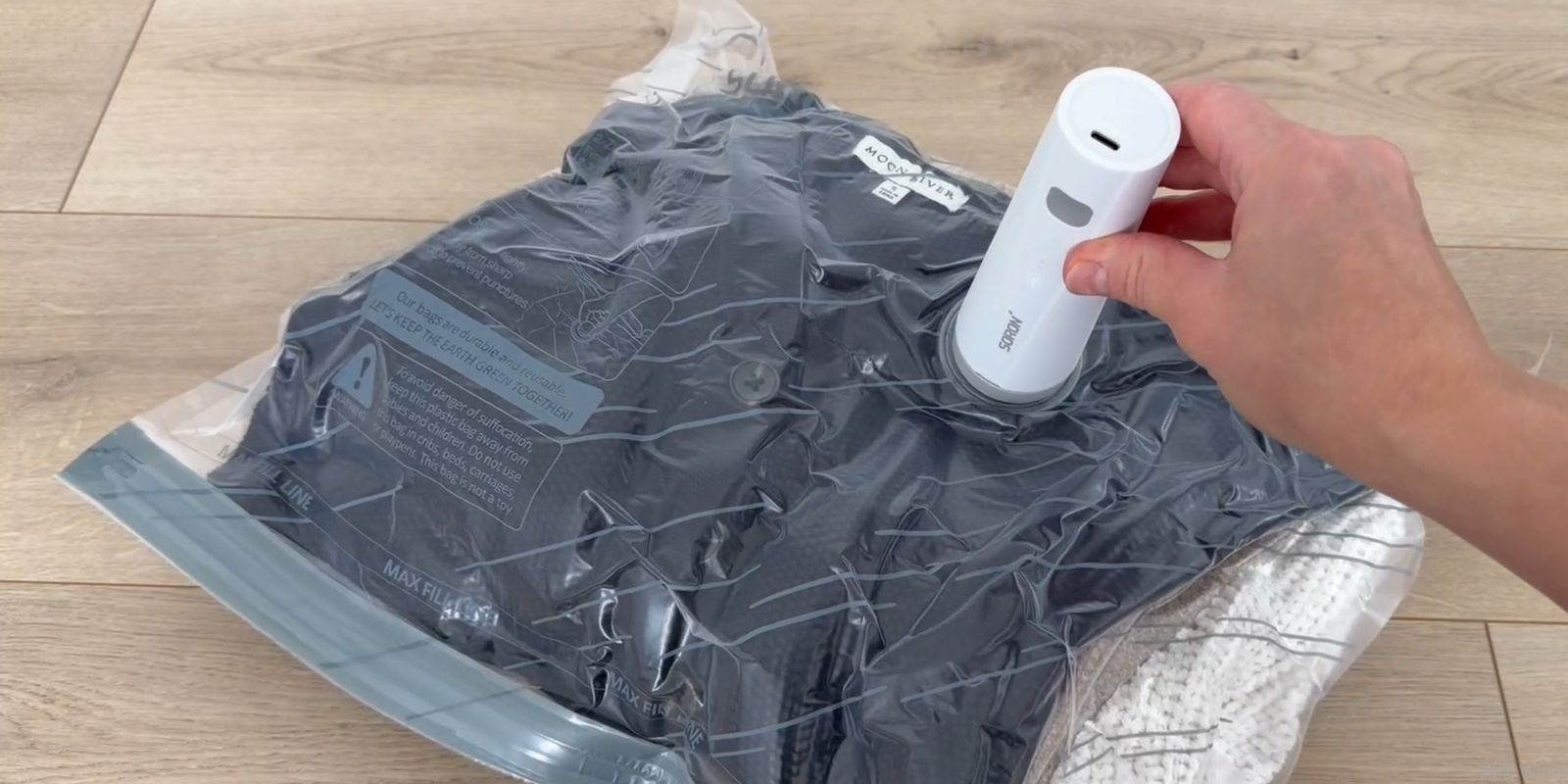 SORON cordless pump compressing a travel vacuum bag